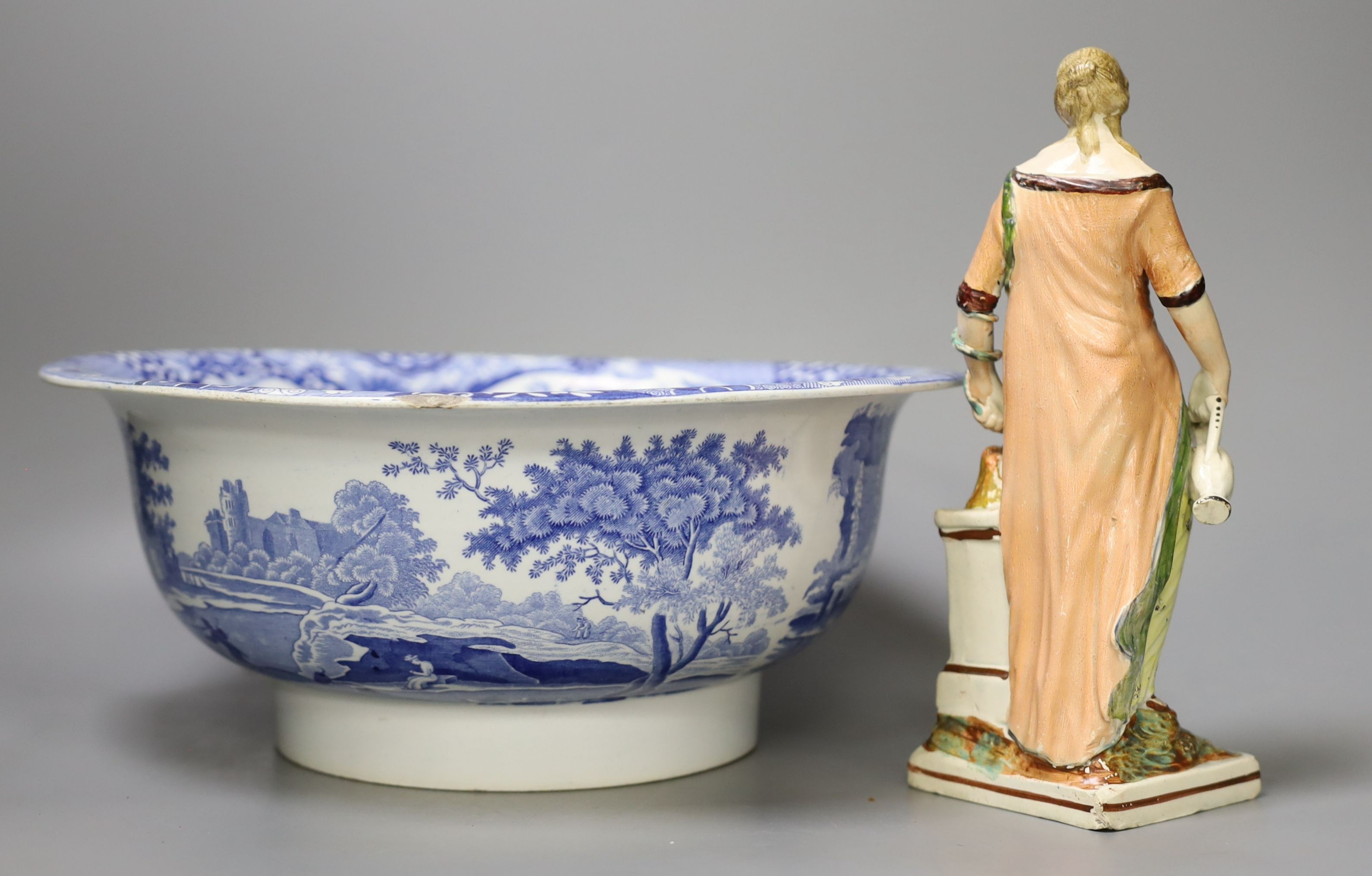 An early 19th century pearlware figure of a maiden, 24cm tall, and a Spode Italian bowl